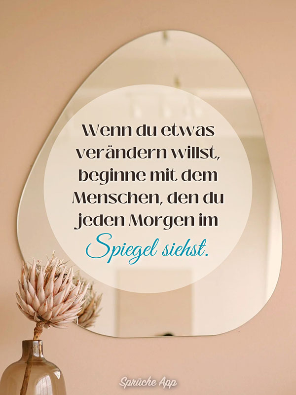 Spiegel auf einer Rosa Wand in dem der Spruch steht: „Wenn du etwas verändern willst, beginne mit dem Menschen, den du jeden Morgen im Spiegel siehst.“