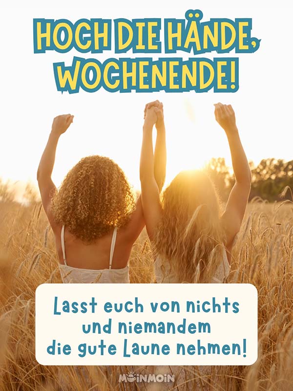 Zwei Freundinnen in einem Feld, die die Hände hochstrecken mit Grüßen: „Hoch die Hände, Wochenende! Lasst euch von nichts und niemandem die gute Laune nehmen!“